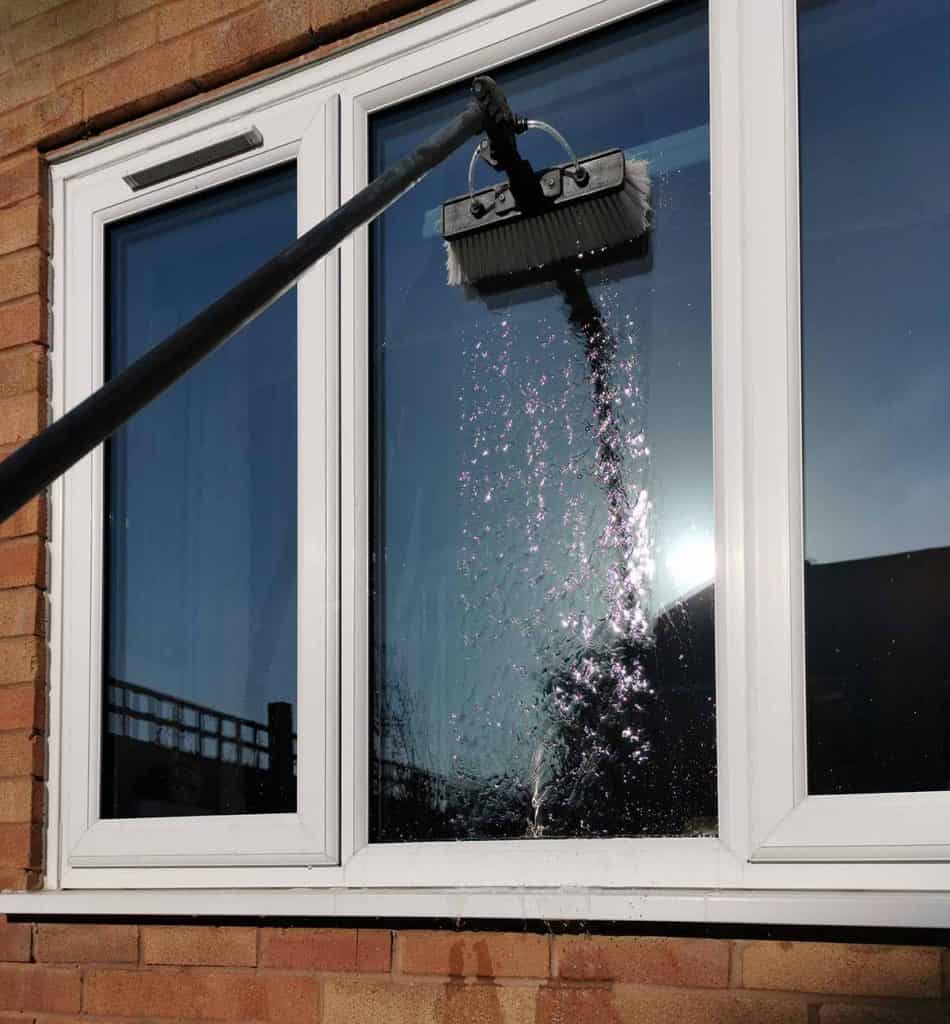 A brush applies ultra clean water to a window to wash all the dirt away